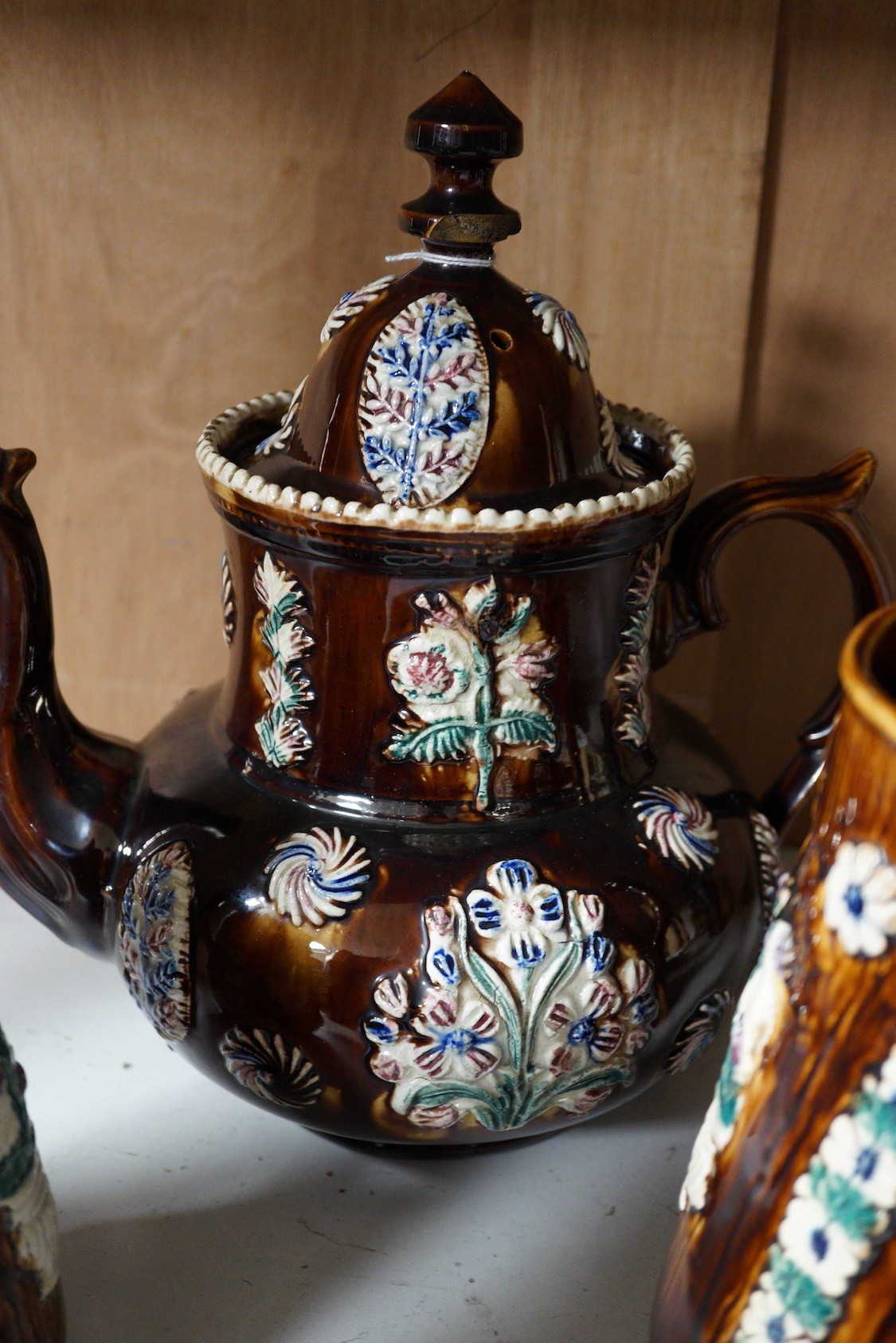A Victorian Measham pottery bargeware teapot and three graduated jugs (4)